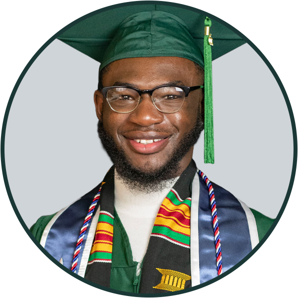 A male student wearing graduation regalia